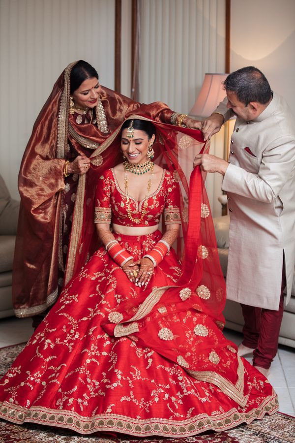 A Beautiful Day Wedding With The Bride In A Ravishing Red Lehenga