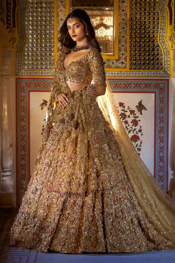 Buy Gold Net Embroidered Floral Sweetheart Metallic Bridal Lehenga Set For Women by Seema Gujral Online at Aza Fashions.