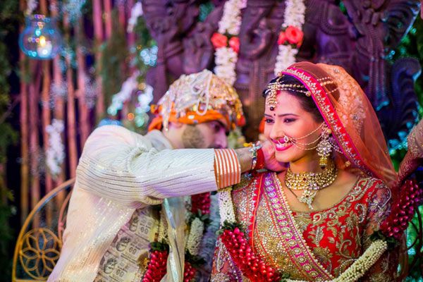 Nikitin & Kratika Had An Arranged Marriage; Kratika Had Royal Bridal Look In Red Pink Orange Lehenga