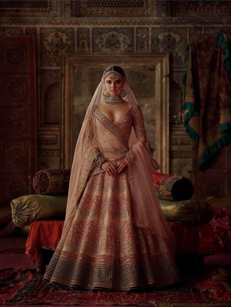 Peach lehenga with red and golden embroidery