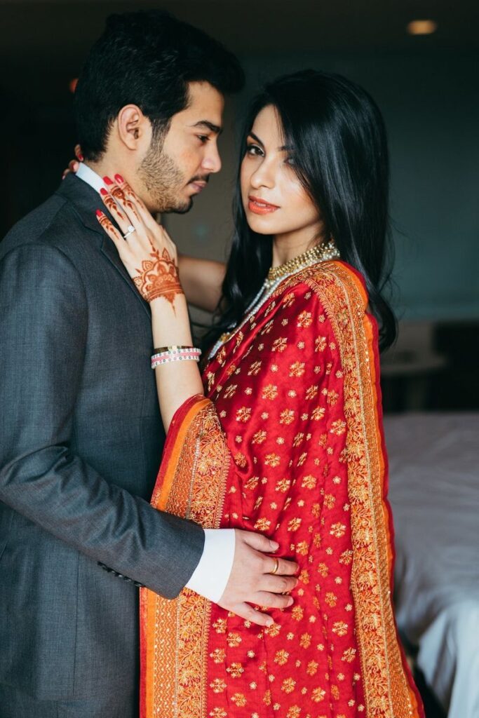 Photo of Romantic couple shot with bride wearing red dupatta