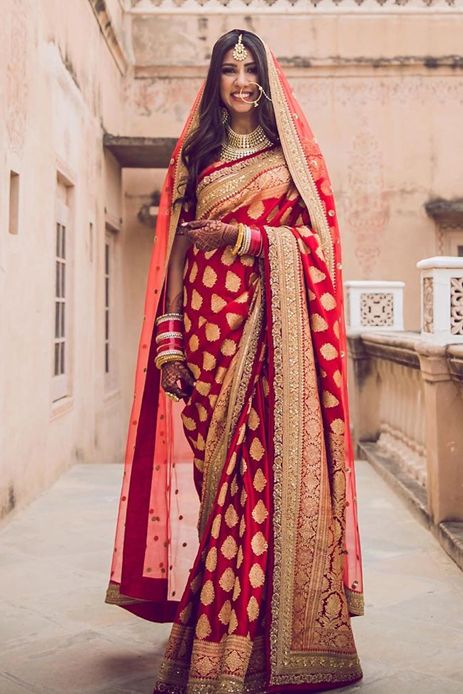 Rich red and gold Banarasi saree with a dupatta by Sabyasachi Mukherjee