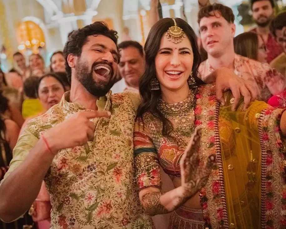 Vicky Kaushal in bandhgala jacket paired with Katrina Kaif in multi-colored silk Sabysaschi lehenga