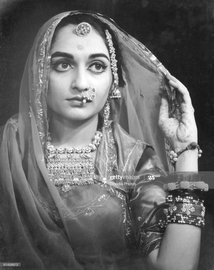 An Indian bride in Rajasthan, 1940s. Her hand is decorated with…