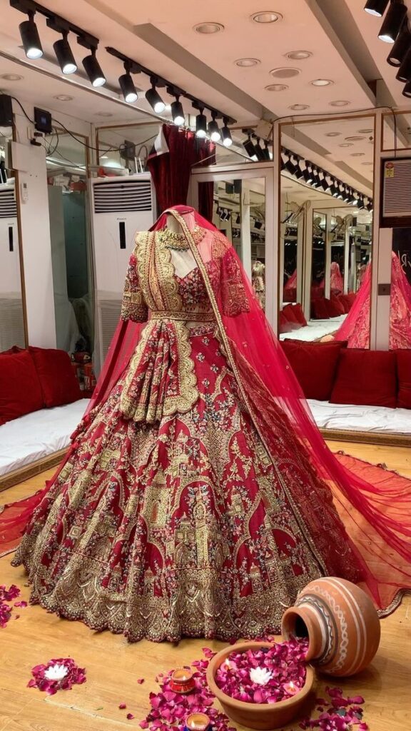 Based on pure raw silk dyed a crimson red, the outfit features Mughal archival domes and stunning Indo-Islamic architecture rendered using techniques of zardosi and aari with resham, sequins, pot, nakshi, zari and dabka.  . Outfit : @sudhirbhaisareewala . #2023Weddings #TheHouseofSudhirBhai #SBBespoke #BridalCouture #IndianBride #IndianWedding #BridalLehenga #BigFatWedding #SBCraftsmanship #RoyalBrides #Bridalgoals #BridesofSudhirBhai #SudhirBhaiBride #BridesofIndia #BridalLook #IndianWeddingBlogger #WedMeGood | Sudhir Bhai Saree Wala