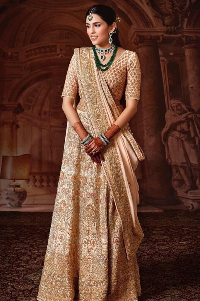 Brides, Shloka Ambani’s peach and gold Abu Jani Sandeep Khosla lehenga is perfect for your pheras