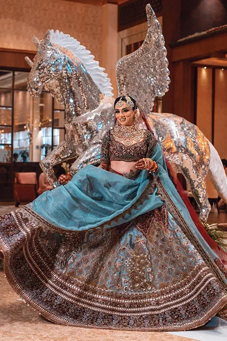 Indian Bridal cerulean blue lehenga with brassy floral overlay